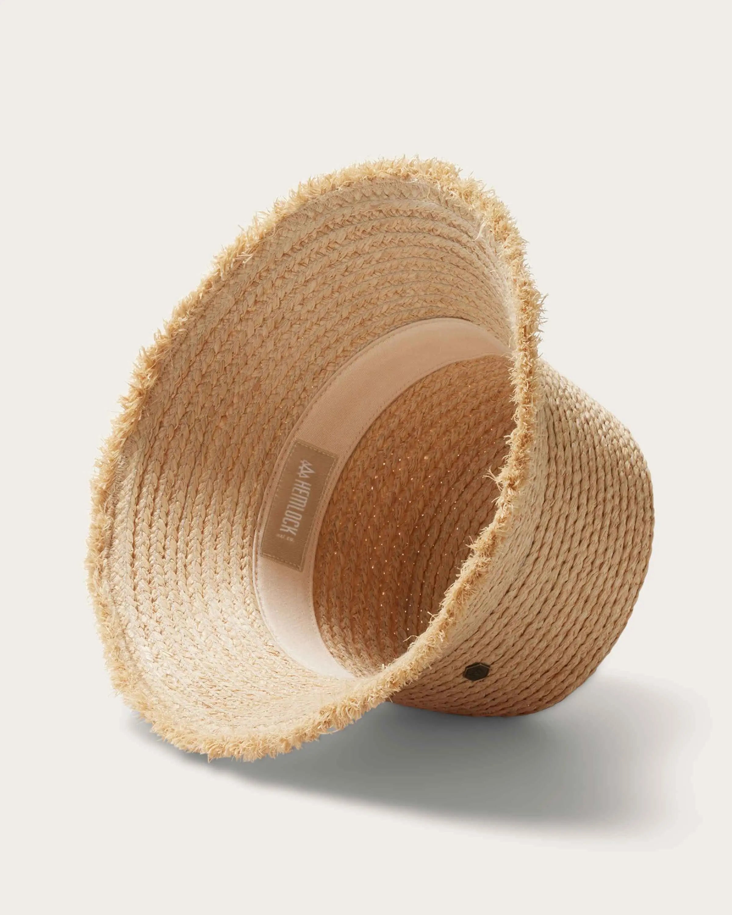 Natural Color Bucket Hat - Hand-woven raffia hat with a wide brim and adjustable size, perfect for a casual summer style.
